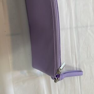 Women’s violet colored clutch bag with removable strap